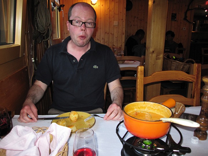 IMG_1898.jpg - In La Fouly.  Dan finding the temperature of the Swiss fondue a little hot