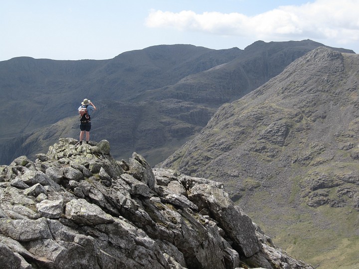 IMG_3391.JPG - A little diversion to the top of Esk Pike.  Another walker looking across to Scafell Pike in the right distance.  Ill Crag (?) on the right.